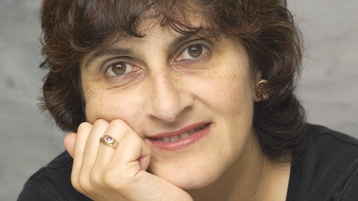 Close-up portrait of writer Moniza Alvi smiling.