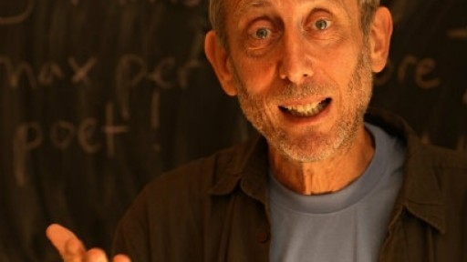 Image of Michael Rosen in front of a blackboard