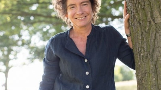 author Jeanette Winterson standing next to a tree