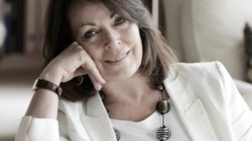 Image of Rose Tremain dressed all in black and white, with a large beaded necklace