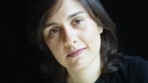 Image of Kamila Shamsie dressed in black, on a black background