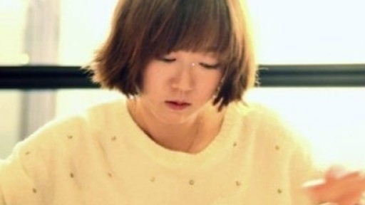 Soft image of Hwang Jung-Eun caught up in reading a sheet of paper on the table in front of her