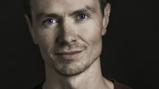 Head and shoulders image of Gavin McCrea with slight stubble and a half-smile