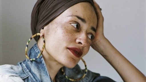 an image of the author Zadie Smith with her hand on her head looking away from the camera