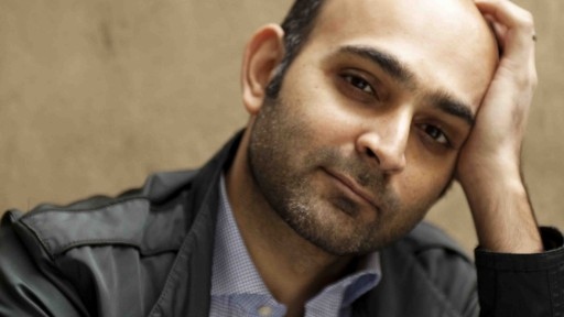 Photo of Lahore author Mohsin Hamid leaning his head on his hand