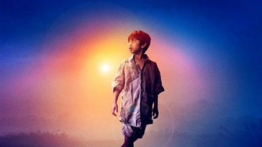 Actor who is a young boy alone with sun behind him