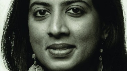 Headshot of Arundhathi Subramaniam, wearing large, leaf-shaped silver earings