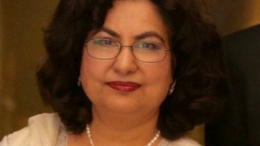 Qaisra Shahraz in white linen top and pearl necklace