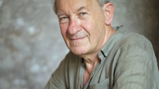 Image of Simon Schama in a beige linen shirt, sitting in front of a stone wall