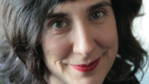 Image of a smiling Sinead Morrissey with dark brown bobbed, wavy hair and red lipstick