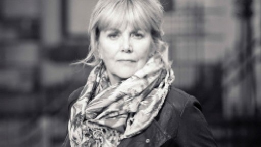black and white photo of Kate Atkinson in a leather jacket and big scarf