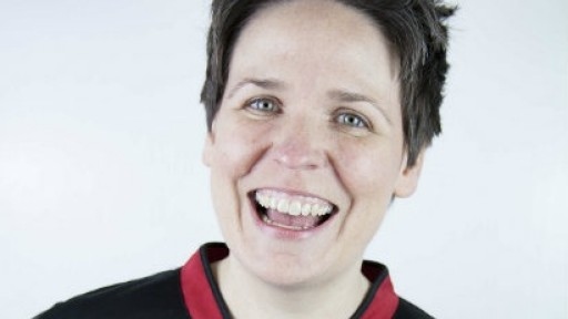 Head and shoulders shot of Comedy Workshop leader Kate McCabe, smiling broadly