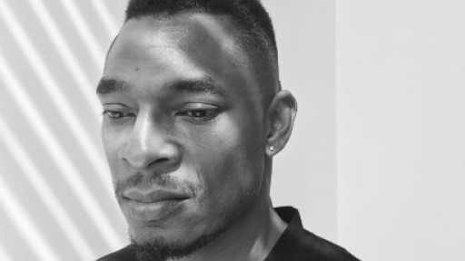Black and white headshot of poet Terrance Hayes, taken slightly from the side, he is looking down