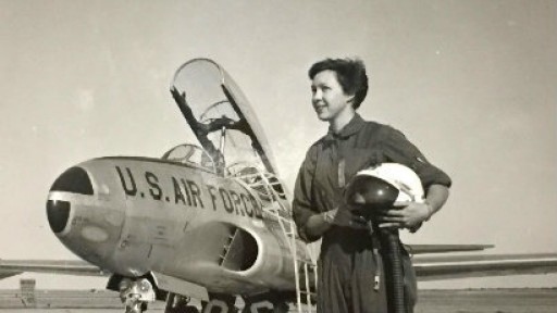 Black and white photo of Wally Funk, aged 22,  standing next to an airforce plane