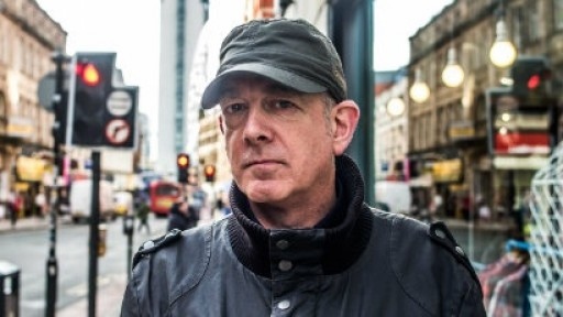 Headshot of DJ and author Dave Haslam in the street
