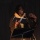 Head and shoulders image of poet Isaiah Hull performing his work on stage