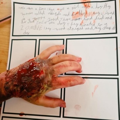 Image of a horror made-up hand on a page