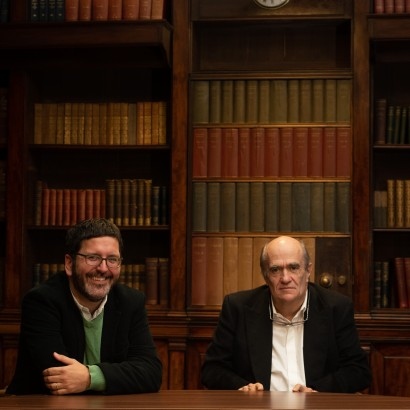 John McAulliffe & Colm Tóibín sat at table in Chief Librarian's Office in Central Library